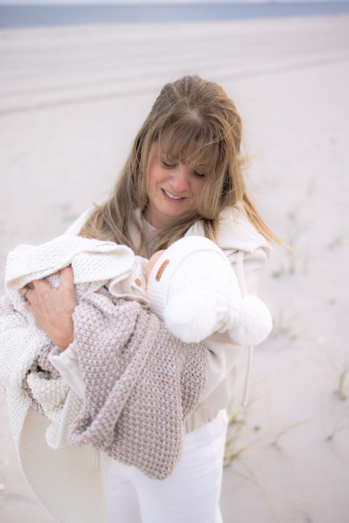 Grandmother holding grandchild during Central Florida beach family session