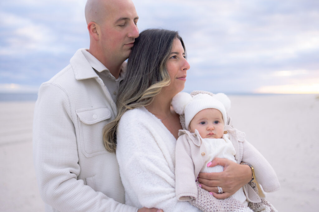 Family enjoying peaceful beach walk during sunset portrait session