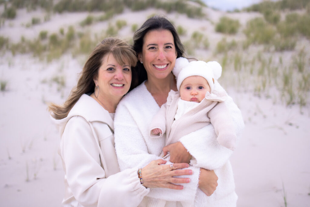 Multi-generational family posing together during sunset beach session