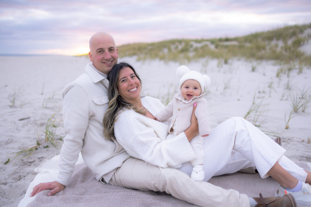 Parents holding baby during beach family photography session