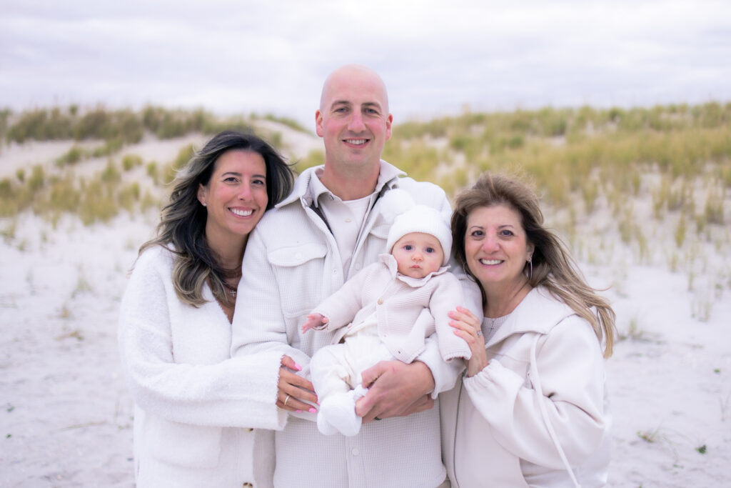 Parents and grandmother enjoying sunset family photos on the beach