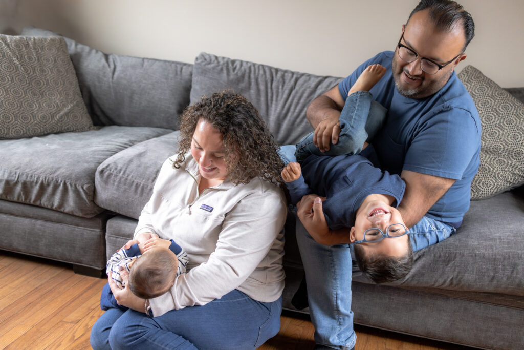 Father holding newborn during relaxed lifestyle family portraits