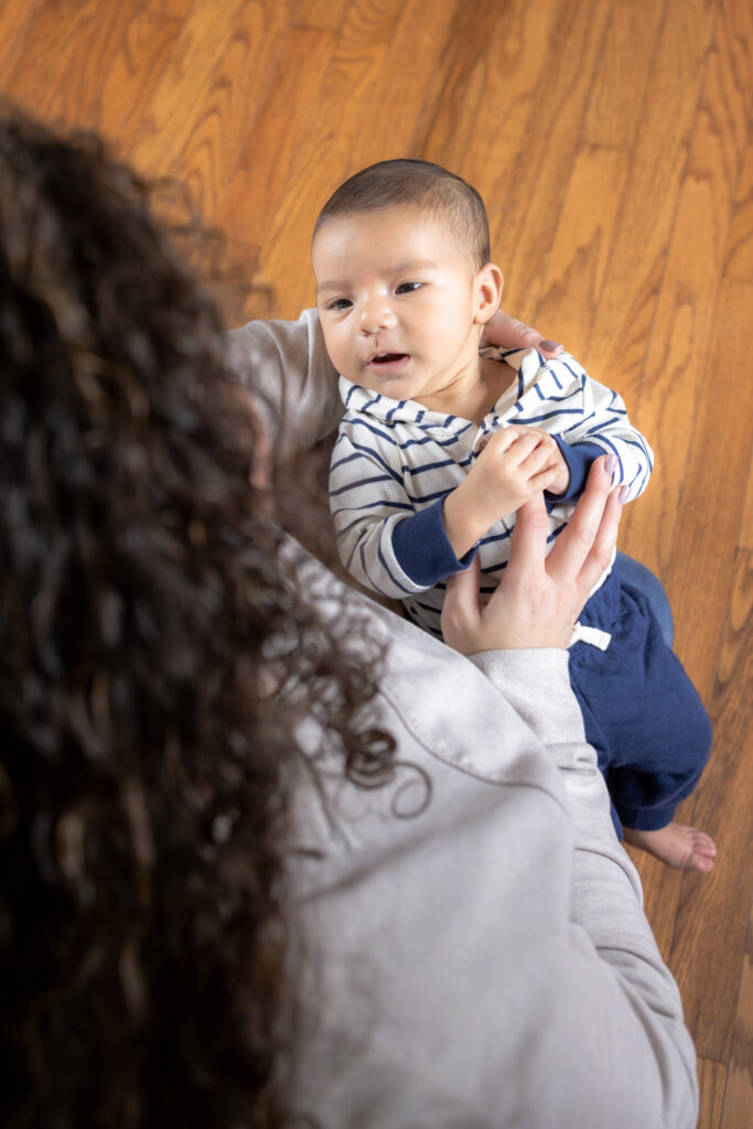 Mom with newborn baby during natural in-home family photoshoot