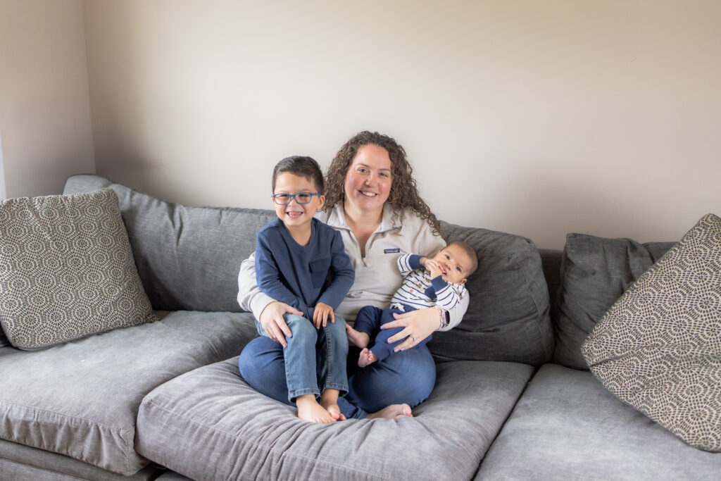 Mom with toddler and baby during natural in-home family photoshoot