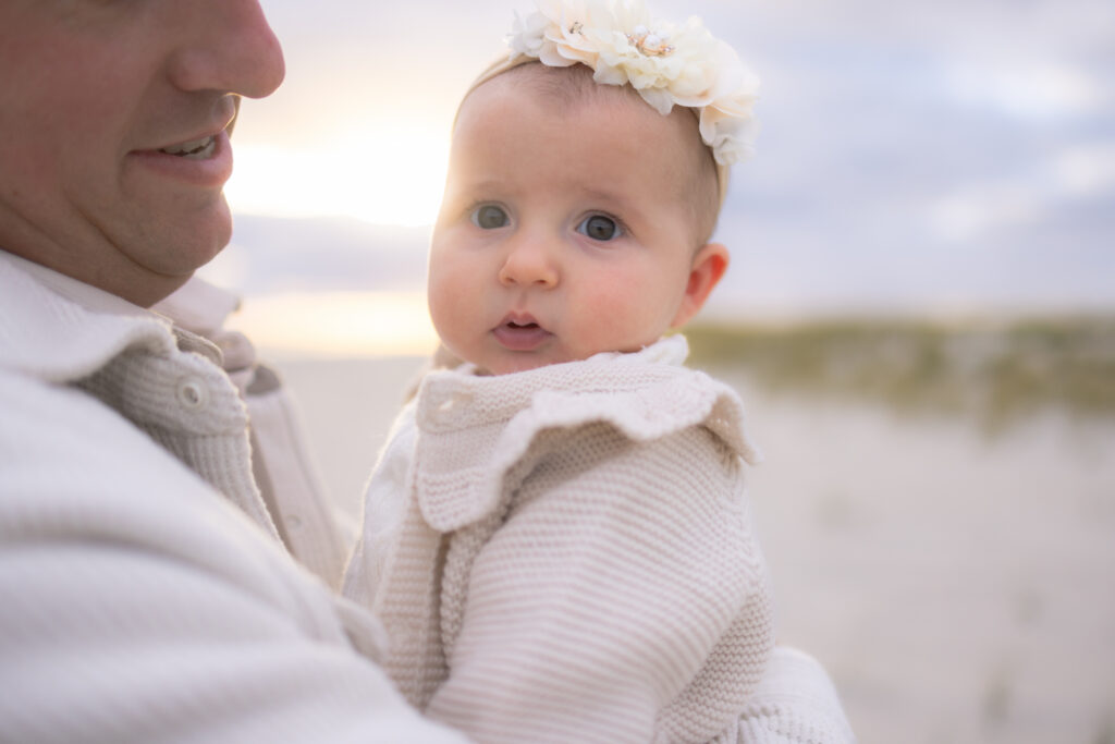 Multi-generational family photography session at beach during golden hour