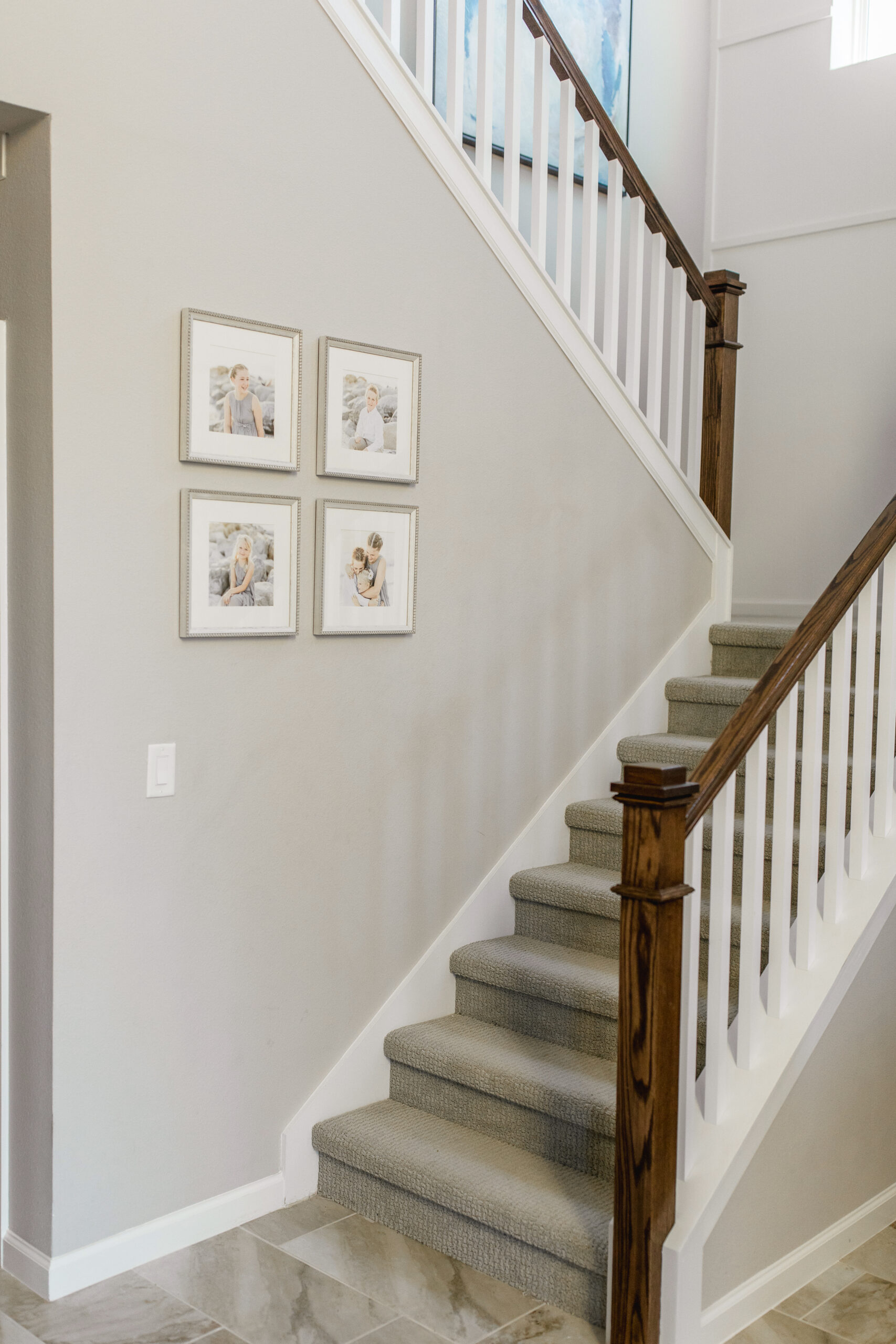 Framed family portraits displayed on living room wall in Central Florida home