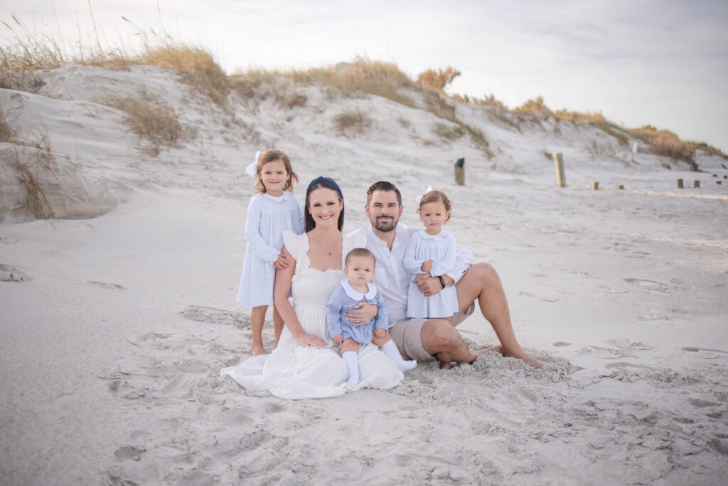 Expectant parents sharing a quiet, emotional embrace while gently cradling the baby bump during a sunset session in Maitland.