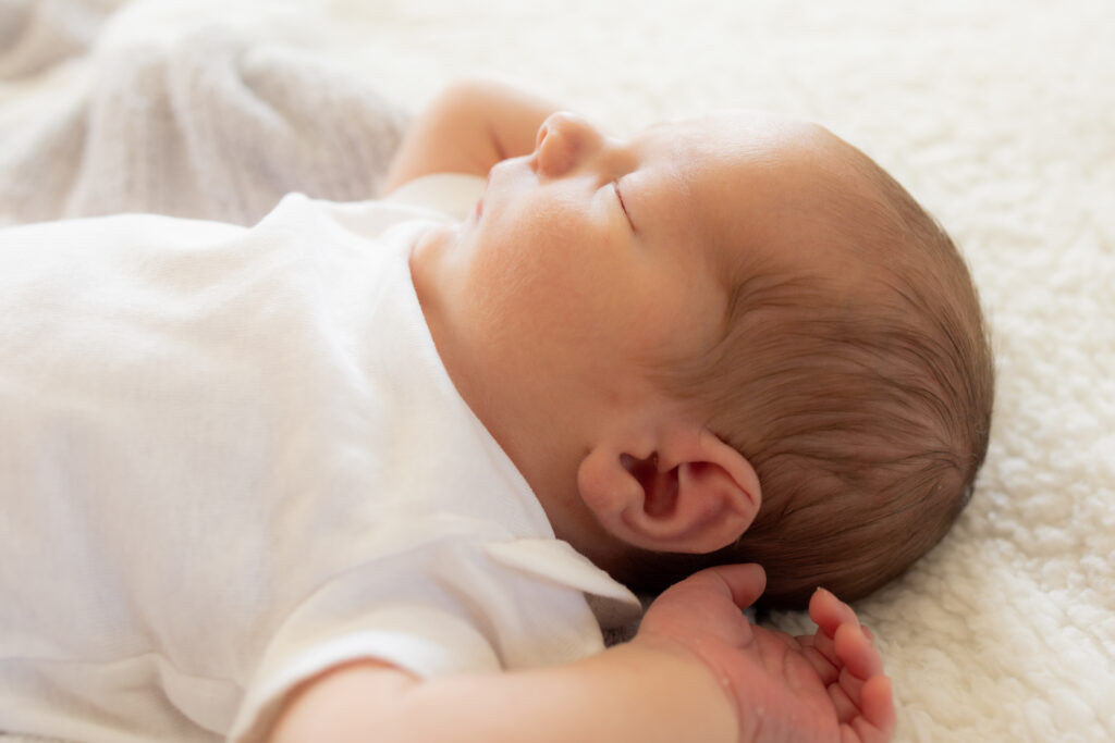 close up portrait of newborn sleeping with parents